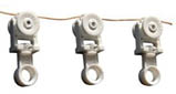 Three white objects with holes in them hang from a wire. AI generated content